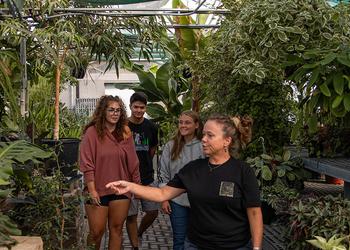 U of M Crookston instructor Theresa Helgeson and and students walking through the greenhouse